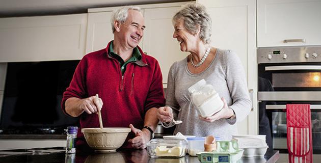 Elderly couple cooking together in the kitchen